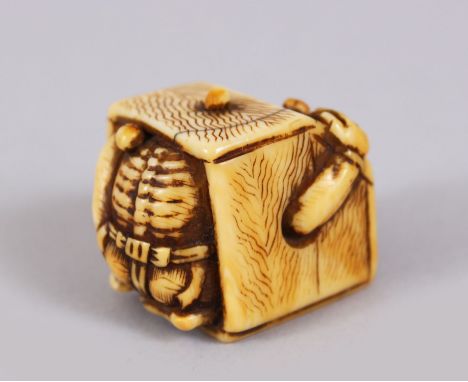 A 19TH CENTURY JAPANESE IVORY NETSUKE SHOKI in a rice box.