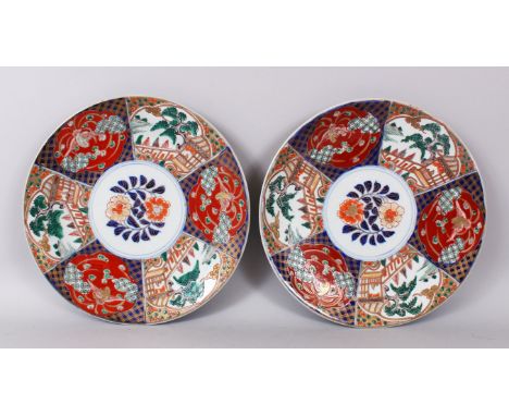 A PAIR OF JAPANESE CIRCULAR DISHES, with central panel of flowers, surround by six panels of birds etc.