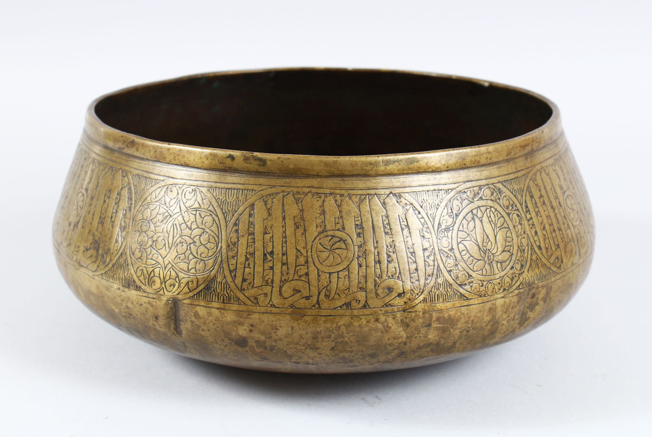 A 14TH CENTURY MAMLUK BRASS BOWL, EGYPT OR SYRIA, the side with an ...