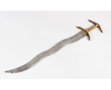 AN 18TH/ 19TH CENTURY SOUTH INDIAN DAGGER with wavy blade, 53cm long.