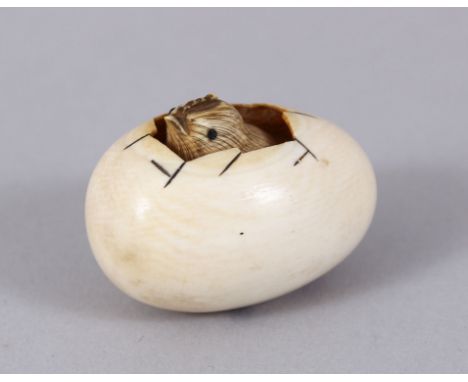 A JAPANESE IVORY NETSUKE, chick in an egg.