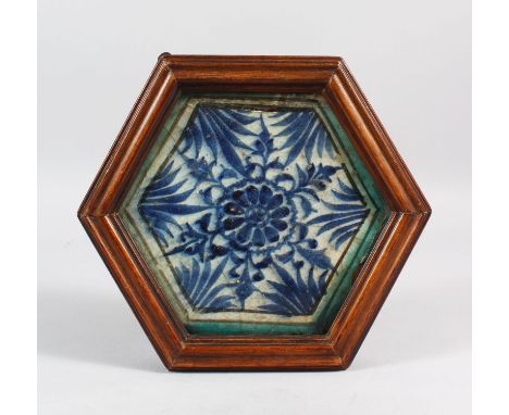 A RARE 15TH CENTURY MAMLUK BLUE AND WHITE POTTERY TILE, PROBABLY SYRIA, 18cm x 16cm in a wooden box frame.