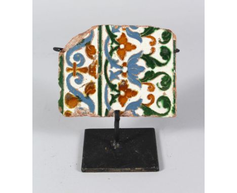 A 16TH CENTURY SPANISH TILE FRAGMENT, 14cm x 11cm.