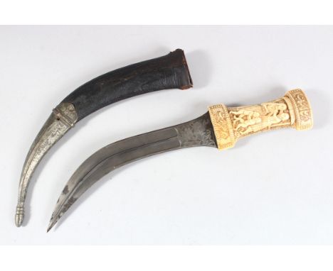 A 19TH CENTURY PERSIAN QAJAR MARINE IVORY HILTED DAGGER with circular watered-steel blade, the handle carved with figures, yo