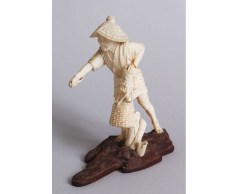 A GOOD QUALITY JAPANESE IVORY OKIMONO ON A WOODEN STAND, an old Japanese man stood with his hand upon a stump containing a ba