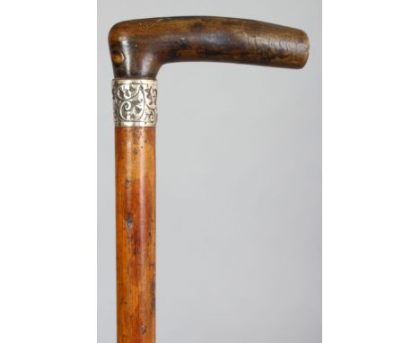 ANOTHER HORN HANDLED WOOD WALKING STICK, the horn possibly rhino horn, the stick with a hallmarked and embossed silver collar