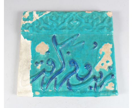 A 14TH CENTURY ILKHANID PERSIAN KASHAN POTTERY TILE with Quranic script in blue, 27cm x 29cm.