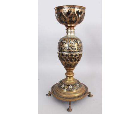A BRASS LAMP, PROBABLY MORADABAD, NORTHERN INDIA, CIRCA 1920-30, the bulbous body formed around a coconut shell with openwork