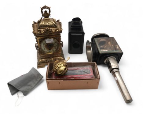 A French brass clock with DC Co movement, a magic lantern, slides and a coach lamp Condition Report:Available upon request