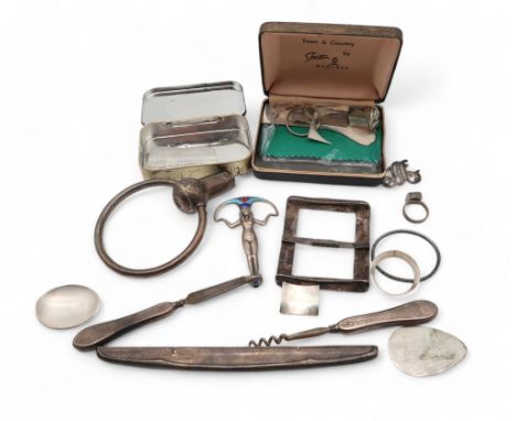 A silver letter opener? finial, modelled as an Egyptian figure, silver offcuts, ring blanks, part of a rattle , pewter belt b