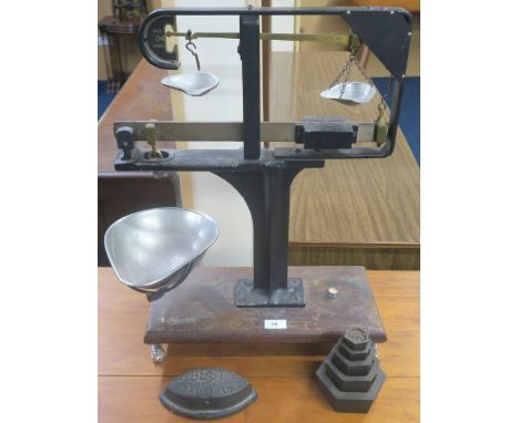A set of early 20th century cast iron and brass Avery Ratio scales, a graduated set of Avery weight (100 grams-2 kilograms) a