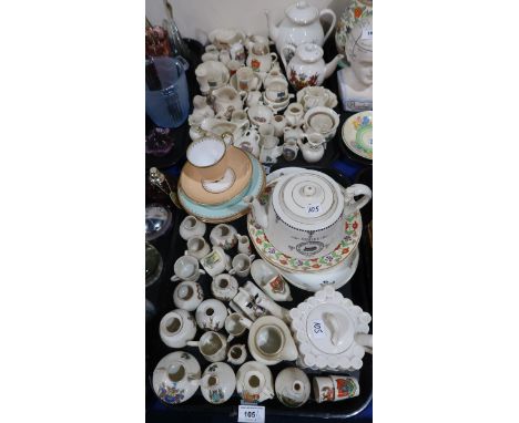 A collection of crested china and other ceramics including a Goss City of London / Lewisham teapot, a Welsh crest teapot, man