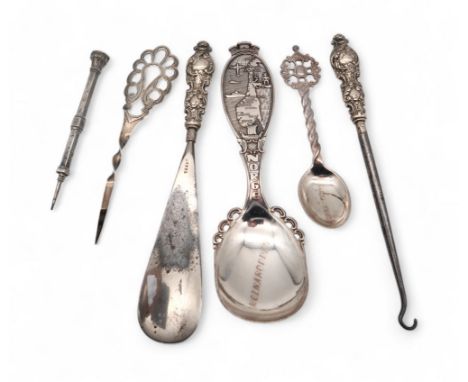 A silver shoe horn and button hook, a white metal propelling pencil, inset with a paste stone, a silver hair piece by Pearce 