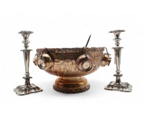 An impressive EPNS punch bowl and six cups, chased with scrolling foliate decoration, together with a silver toddy ladle by F