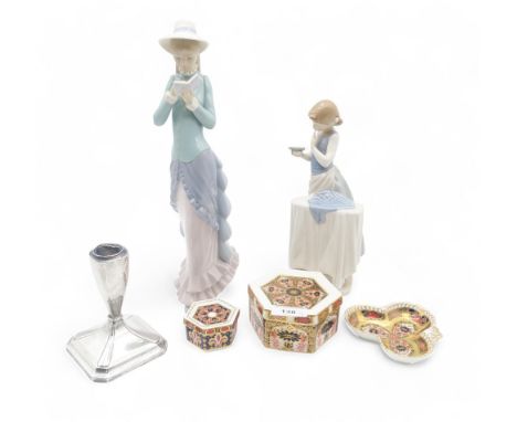 A weighted silver candlestick, two Royal Crown Derby hexagonal trinket boxes and a trinket dish, together with two Lladro fig