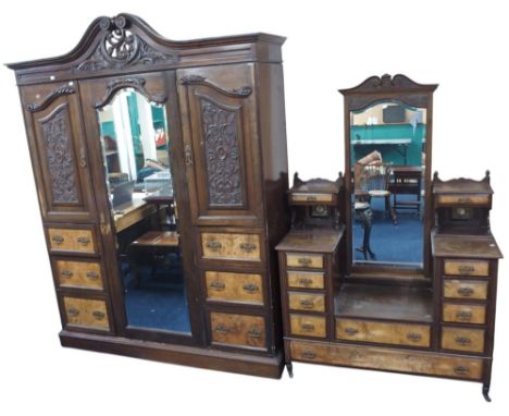 A Victorian mahogany and burr walnut inlaid bedroom suite consisting wardrobe with carved scrolled cornice over central bevel