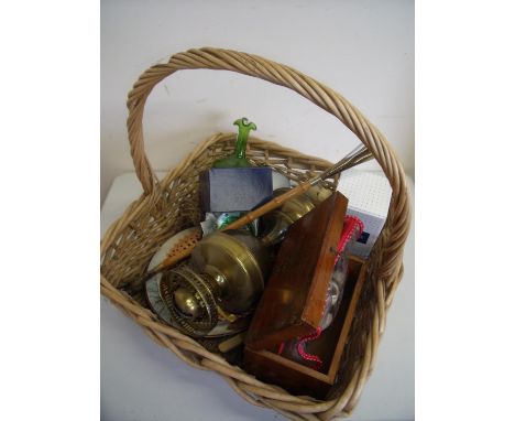 Large wicker basket containing a quantity of various assorted items including an oil lamp, boxed glass paperweight, rose quar