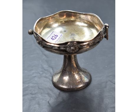 A George V silver pedestal dish, of Arts and Crafts design with repeating Celtic knot decoration, the circular bowl raised on