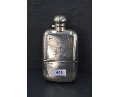 An Edwardian silver spirit flask of plain form with engraved monogram to side, bayonet lid and removable drinking cup, Sheffi