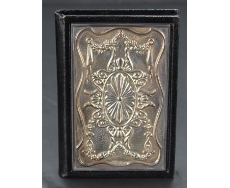 An Elizabeth II silver mounted black leather address book, of typical form, the front board mounted with embossed silver pane