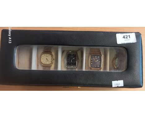 4 wrist watches in display case to include Rotary, Citizen Eco-Drive, Roamer and silver Denacci (untested) 