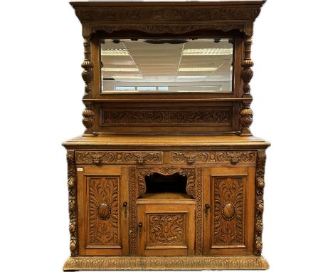 19th century oak dresser, the moulded cornice above a mirror back and open shelf flanked by turned columns, the lower with tw
