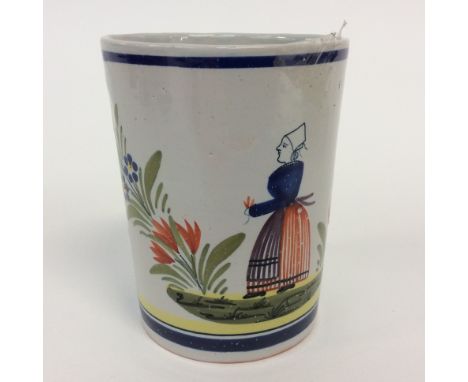 A late 19th Century early mark HB Quimper beaker with Bretonne lady figure and floral sprigs, measuring 10.5 cms high - one s