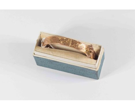 A 9ct rose gold bangle, belt buckle style with foliate engraving, width approx 9mm, weigh approx  approx 10 grams (in box)