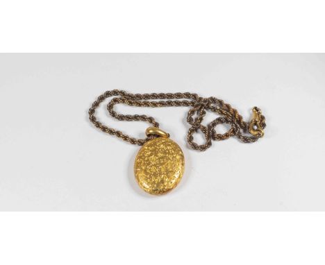 A Victorian 15ct gold oval locket with foliate and scroll engraving  with a total gross weight approx 15.5gms, on a 9ct gold 