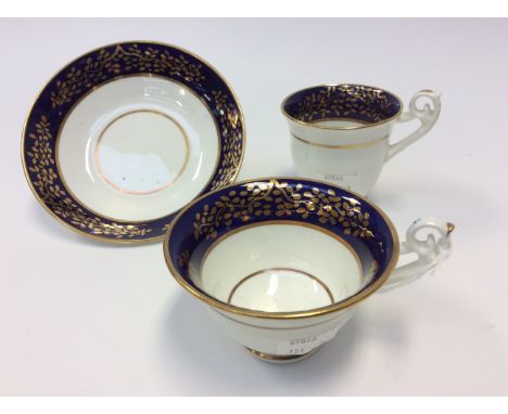 An English porcelain trio, tea and coffee cup and saucer, cobalt blue and gilt borders, pattern No.2721, probably Spode but a