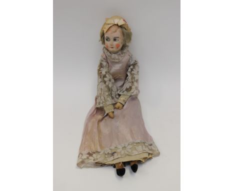 A 1920's doll, in original clothing, body stuffed velvet, head composite in the style of Norah Wellings, (early Chad Valley) 