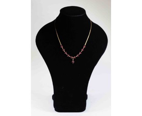 A ruby and diamond set necklace of trefoil leaf shape links set marquise cut rubies inter-spaced with diamonds, ruby and diam