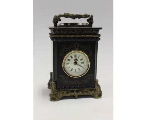 A Victorian style slate mantle clock, wind up mechanism, white face with Roman numerals