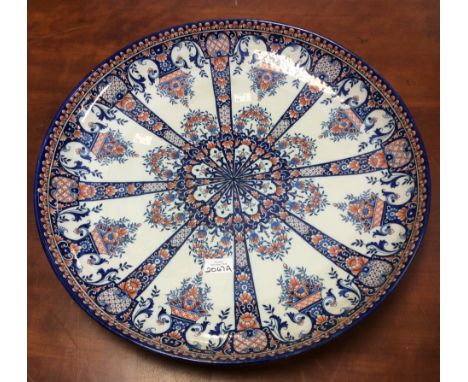 A large HB Quimper dished charger plate in Rouen decor marked P to base for M. Poulain, 54 cms diameter, good condition 