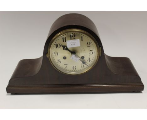 A 1920s mahogany cased mantle clock, having a silvered chapter dial and Arabic numerals