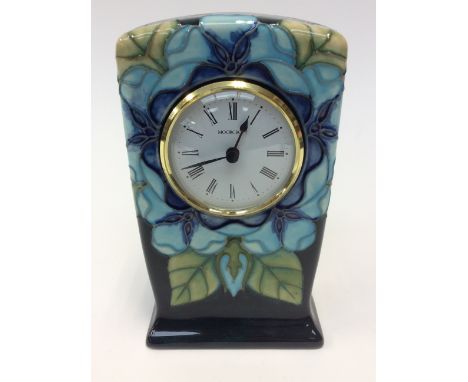 A Moorcroft mantle clock, blue flowers on a cobalt ground, first quality