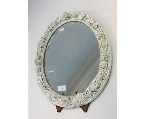 A 19th Century oval easel looking glass, the surround a Derby porcelain floral border in the white, height 46cm (a/f)