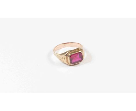 A 10 k Gents signet ring, ring over set octagonal cut synthetic ruby within engraved anthemion shoulders, stamped 10 k