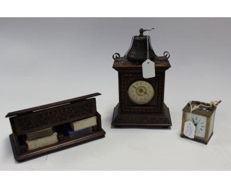 A circa 1880's German alarm clock/mantle clock. Having carved wood with bell as finial and alarm, with a brass carriage clock