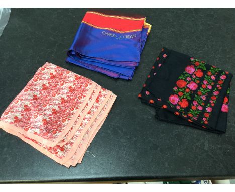 A Charles Jourdan silk 1970's long length scarf in purple; red/gold/yellow colourway and a black printed with red/pink floral