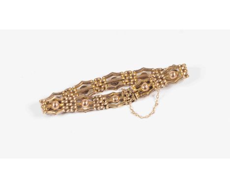 A late Victorian / Edwardian yellow metal gate bracelet, fancy links with ball set to the centre(unmarked) approx 15 grams