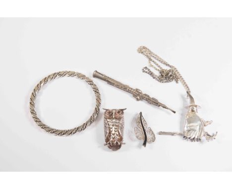 A collection of silver and white metal items including an owl pendant, a bangle, filigree brooch, clarinet brooch, and a witc