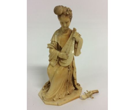 An early 19th Century Japanese ivory carving of a lady playing a lute, (A/F)