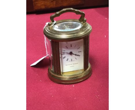 Mid Century Matthew Norman miniature oval shaped carriage clock 7.5 cms high (no key present and A/F)