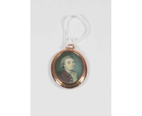 A gold plated oval portrait miniature pendant of a young gentleman in Georgian costume, approx 30mm x 38mm