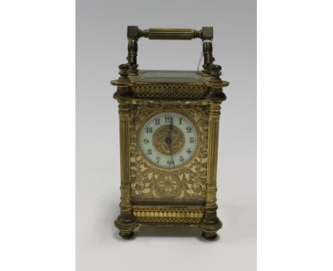 A 19th Century Carriage clock with gilt grille interior and enamel dial