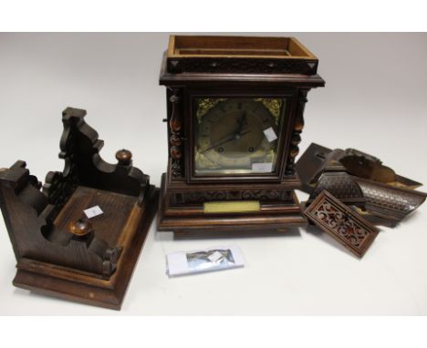 A Tin Tang 8 day mantle clock, with matching wall bracket, Roman numerals, pendulum, key