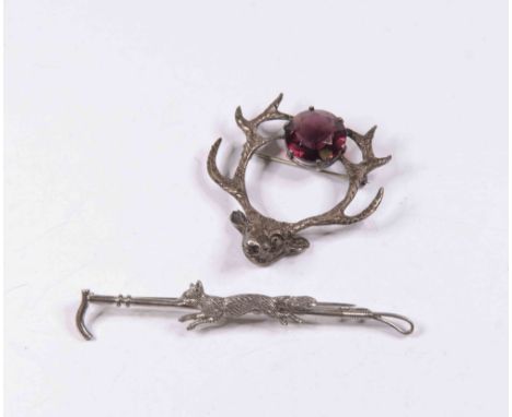 A Scottish interest stag brooch silver, makers mark R A, set with purple paste, along with a hunting crop featuring a fox, wh