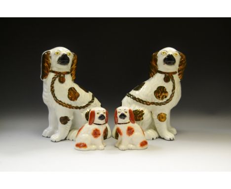 A pair of Victorian Staffordshire dogs, loose front legs, copper lustre patch markings, c.1880;  another pair, smaller, rust 