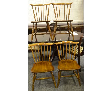 An unusual set of four Ercol 714 fan back chairs, Golden Dawn finish